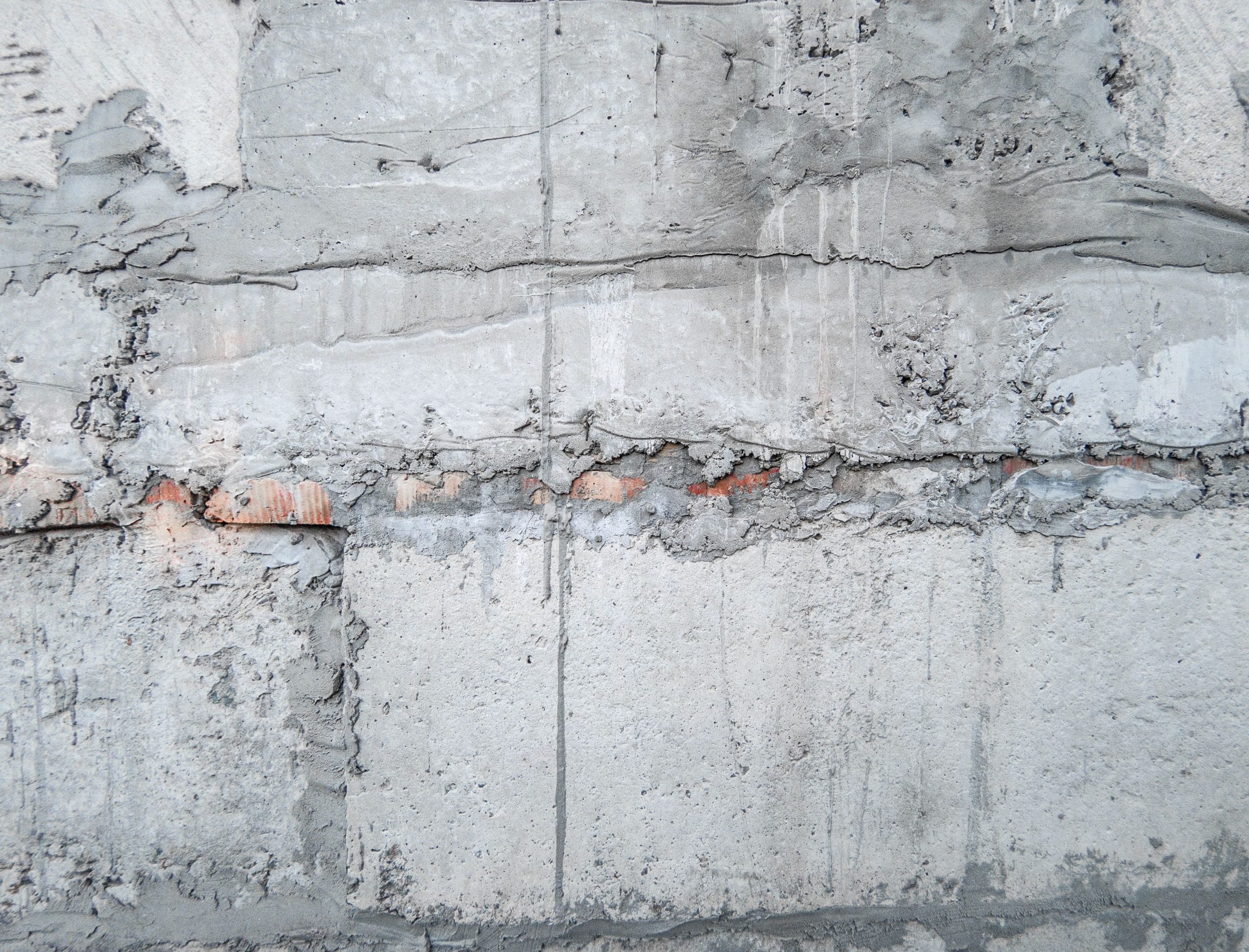 Mur pierre usé enduit gris béton ancien